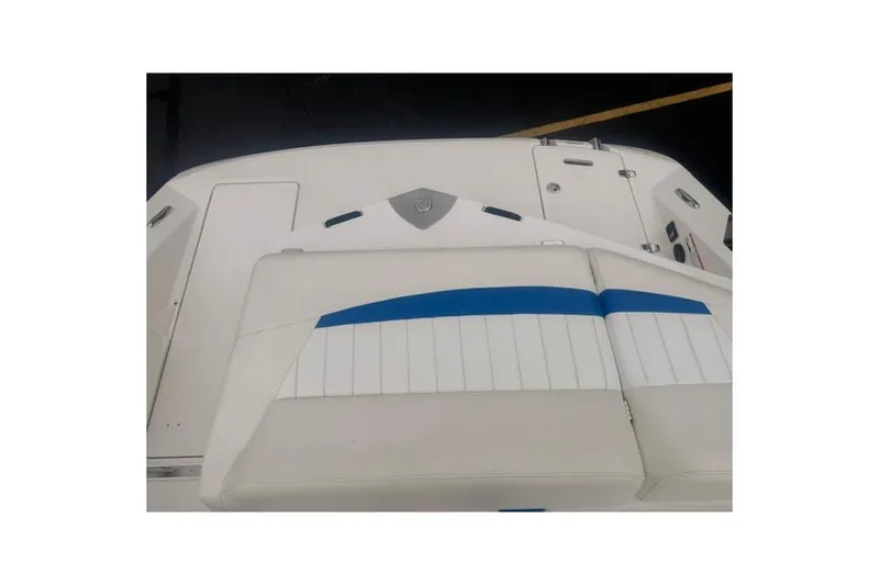 Slide: The Image of 2007 Regal 2200 Bowrider boat interior with white and blue seating. - 28