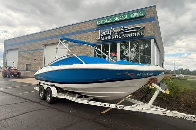 Slide: The Image of Blue 2007 Regal 2200 Bowrider boat on trailer outside Jerry's Majestic Marine. - 30