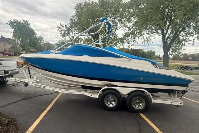 Slide: The Image of 2007 Regal 2200 Bowrider boat on trailer in parking lot. - 33
