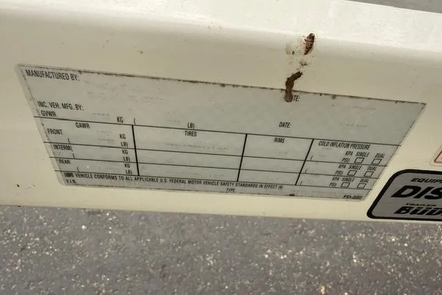 Slide: The Image of Label on 2007 Regal 2200 Bowrider boat displaying tire and rim specifications. - 38