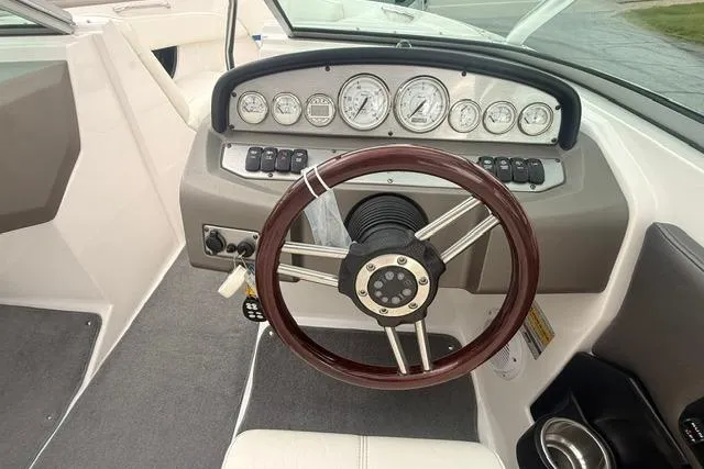 Slide: The Image of 2007 Regal 2200 Bowrider dashboard with gauges and steering wheel, showcasing boat controls. - 6