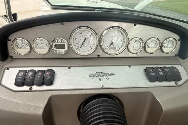 Slide: The Image of Dashboard of a 2007 Regal 2200 Bowrider boat with gauges and controls. - 8