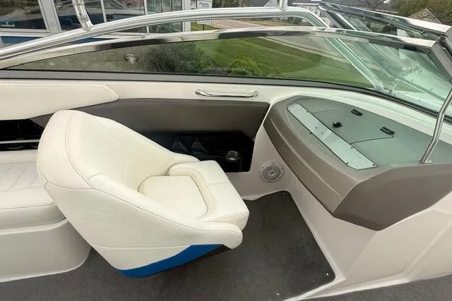 Slide: The Image of 2007 Regal 2200 Bowrider interior with white seating and dashboard view. - 9