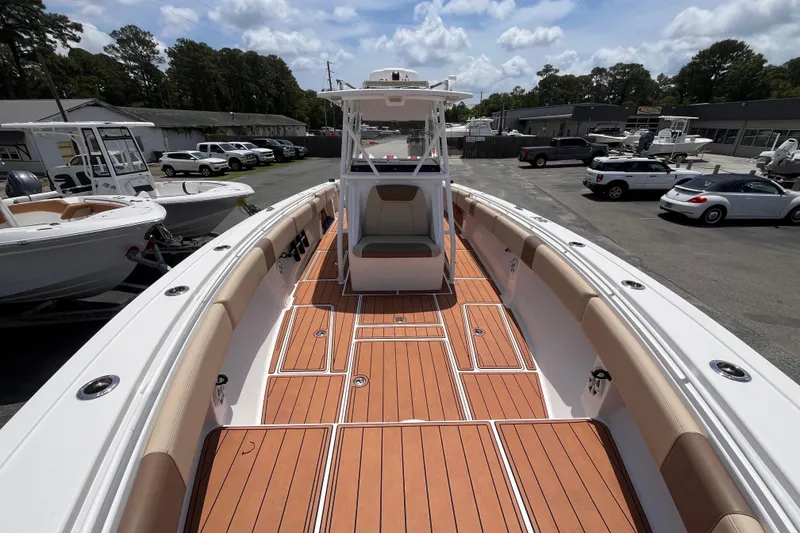 Slide: The Image of 2019 Fountain 38 Center Console boat with teak deck, parked in a marina. - 15