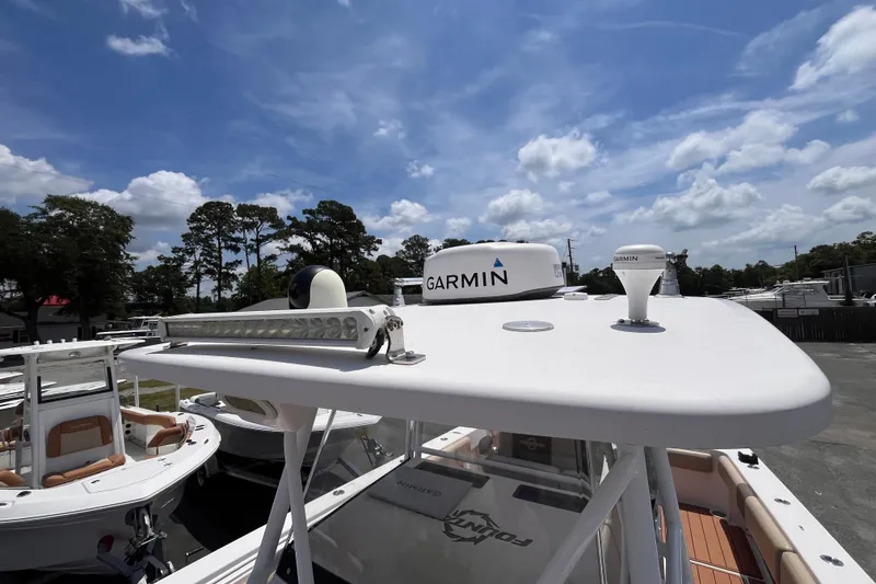 Slide: The Image of 2019 Fountain 38 Center Console boat with Garmin equipment under a clear blue sky. - 16
