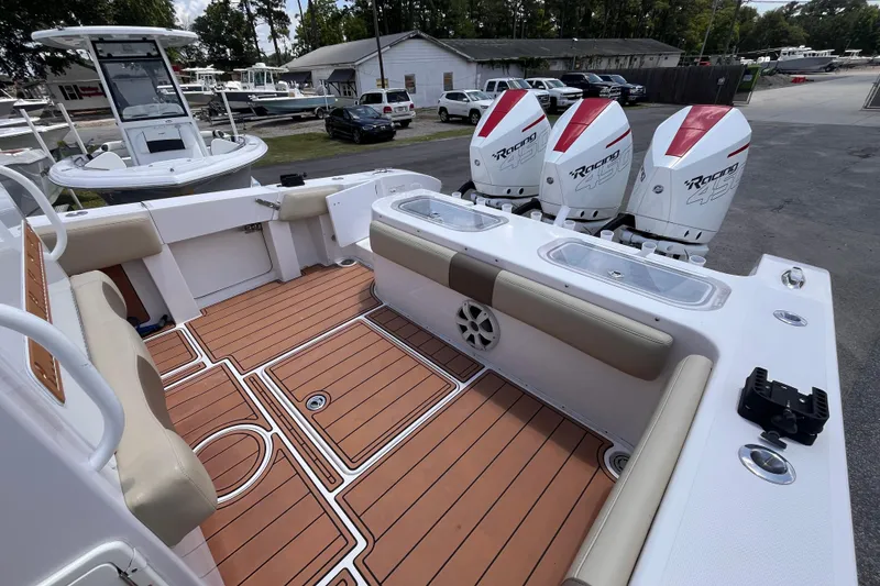 Slide: The Image of 2019 Fountain 38 Center Console boat with triple outboard engines and teak flooring. - 20