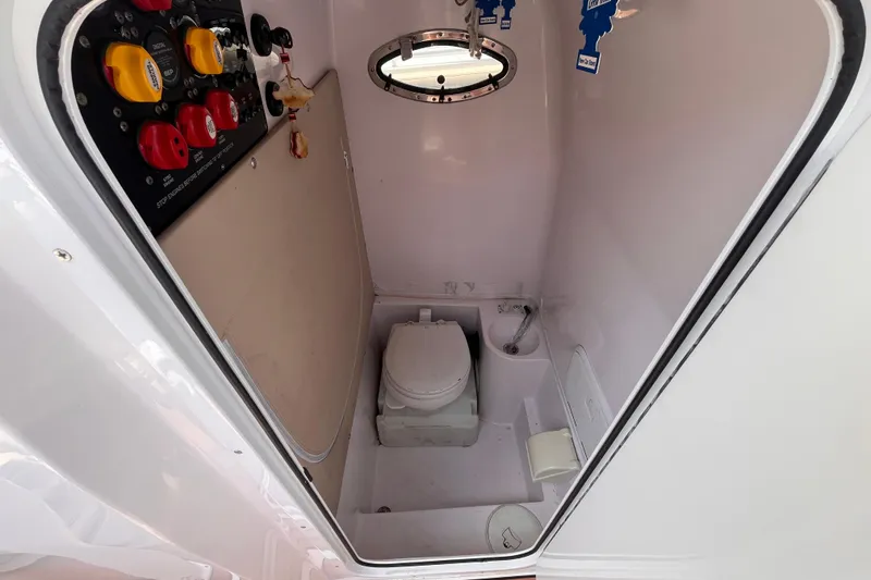 Slide: The Image of Interior of 2019 Fountain 38 Center Console boat with toilet and control panel. - 21