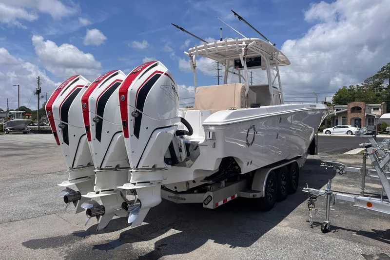 Slide: The Image of 2019 Fountain 38 Center Console boat with triple outboard engines on a trailer. - 5