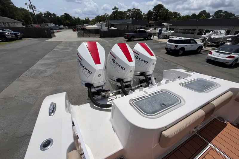 Slide: The Image of 2019 Fountain 38 Center Console with triple outboard engines in a parking lot. - 6