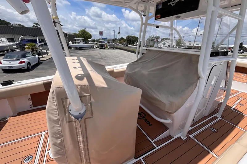 Slide: The Image of 2019 Fountain 38 Center Console boat interior with covered seating and teak flooring. - 8