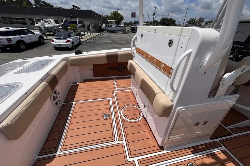 Slide: The Image of 2019 Fountain 38 Center Console boat interior with teak flooring and cushioned seating. - 9