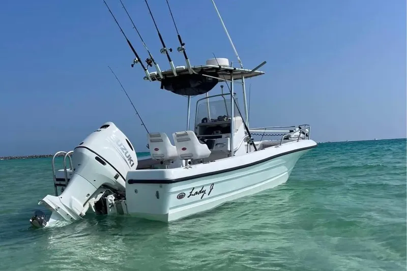 Slide: The Image of 2002 Triumph 210 CC boat with Suzuki engine in clear turquoise water. - 7