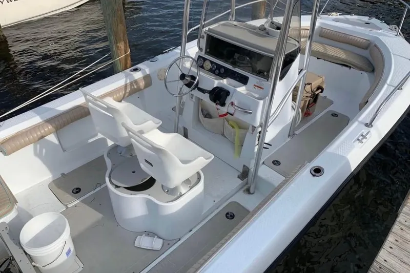 Slide: The Image of 2002 Triumph 210 CC boat interior with dual seats and steering console. - 8
