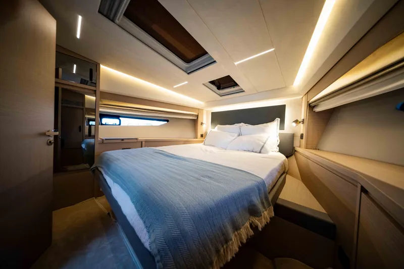 Slide: The Image of Luxurious bedroom interior of 2023 Prestige 520S yacht, featuring modern design and ambient lighting. - 14