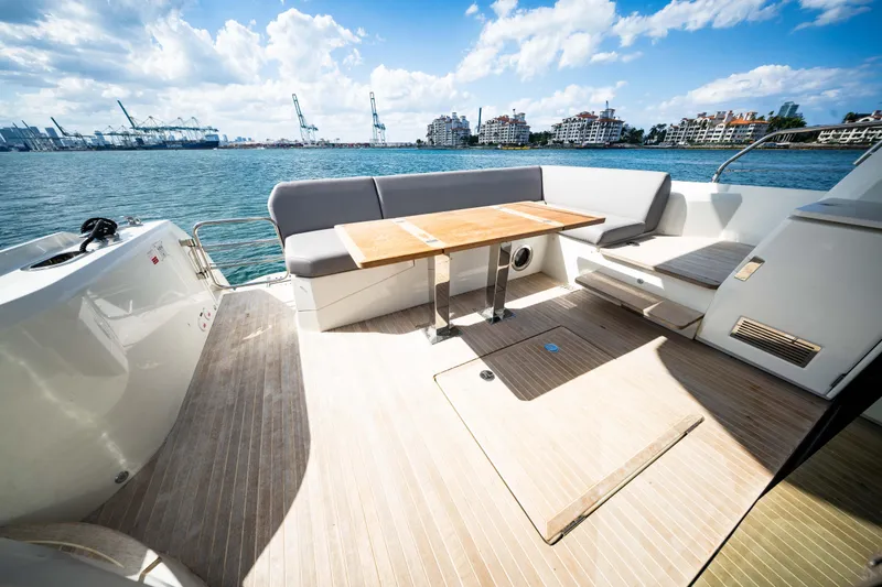Slide: The Image of Luxurious 2023 Prestige 520S yacht deck with seating and table, overlooking scenic waterfront. - 16
