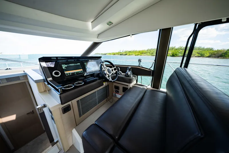 Slide: The Image of Interior of 2023 Prestige 520S yacht with modern helm and leather seating. - 3