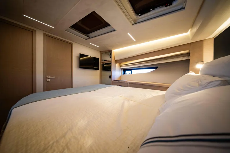 Slide: The Image of Luxurious bedroom interior of 2023 Prestige 520S yacht with modern design and ambient lighting. - 7