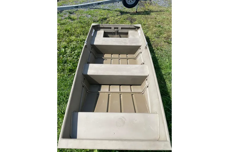 Slide: The Image of 2020 G3 Gator Tough 1036 boat on grass, showcasing interior seating and structure. - 6