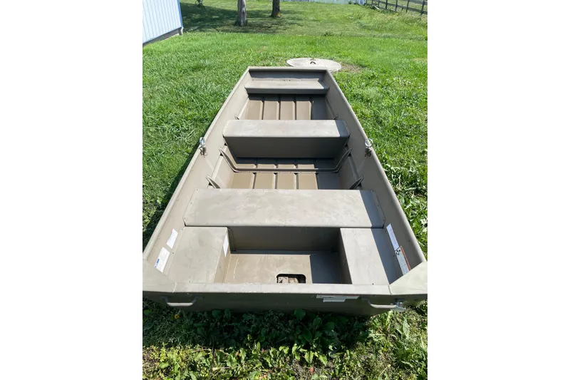 Slide: The Image of 2020 G3 Gator Tough 1036 boat on grass, showcasing interior seating and structure. - 7
