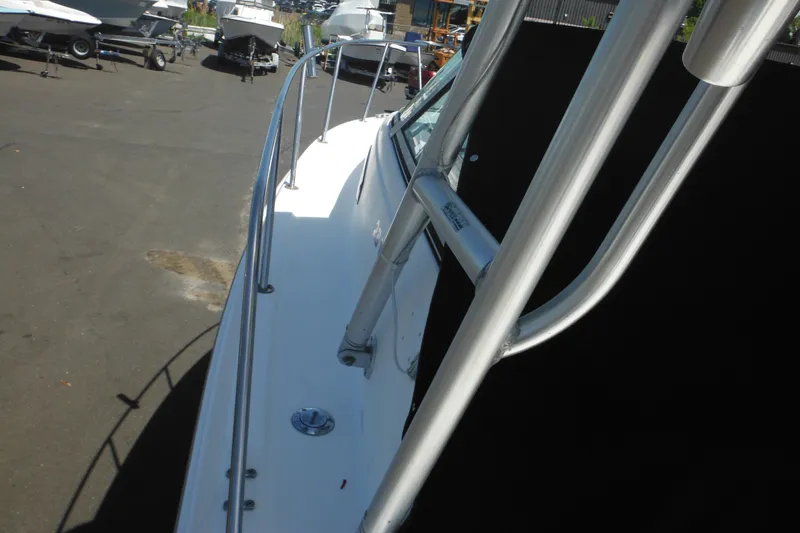 Slide: The Image of 1998 Wellcraft 23 Excel boat side view in a marina setting. - 14