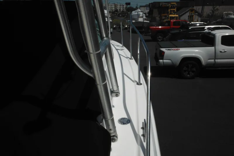 Slide: The Image of 1998 Wellcraft 23 Excel boat with railing, parked near white pickup truck. - 15