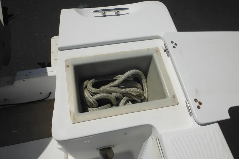 Slide: The Image of Storage compartment with rope on a 1998 Wellcraft 23 Excel boat. - 17