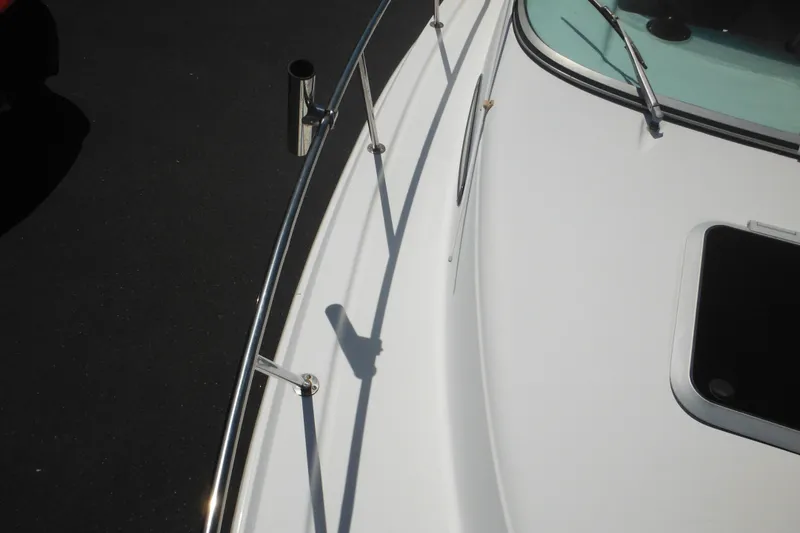 Slide: The Image of 1998 Wellcraft 23 Excel boat deck with railing and hatch. - 26