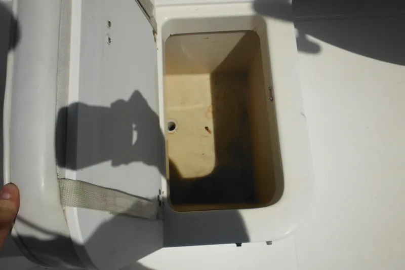 Slide: The Image of Open storage compartment on 1998 Wellcraft 23 Excel boat, showing interior details. - 28