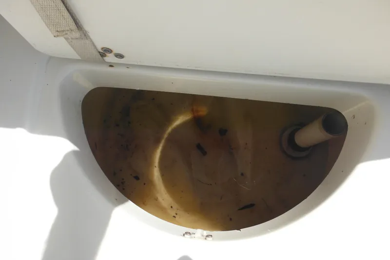 Slide: The Image of Dirty bilge area of a 1998 Wellcraft 23 Excel boat with visible debris. - 31