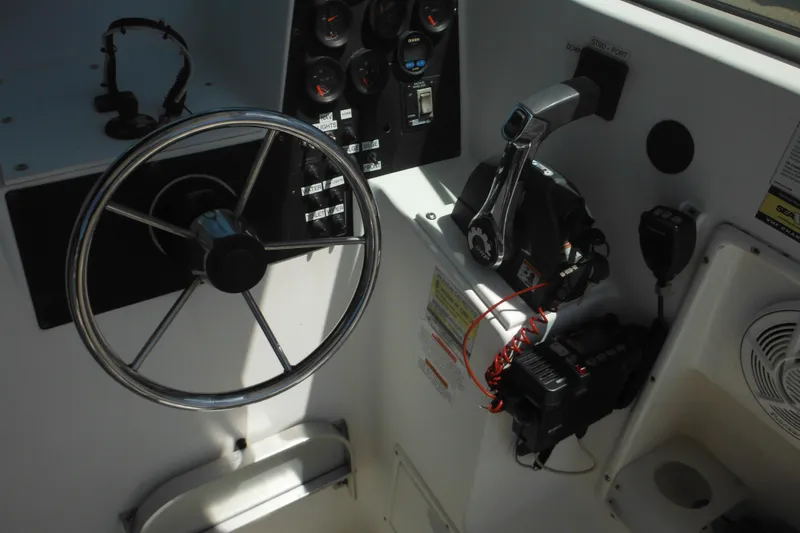 Slide: The Image of 1998 Wellcraft 23 Excel boat dashboard with steering wheel and control panel. - 32