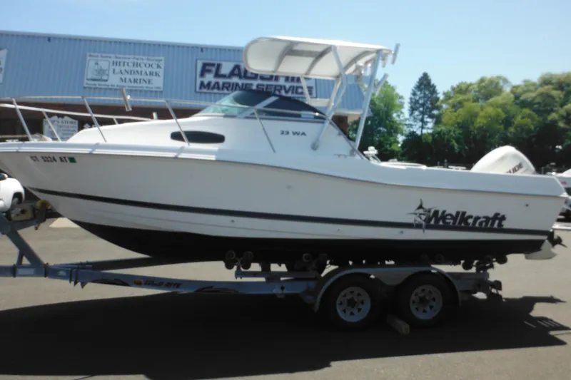 Slide: The Image of 1998 Wellcraft 23 Excel boat on trailer at marine service center. - 4