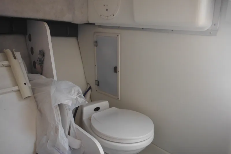 Slide: The Image of Interior of 1998 Wellcraft 23 Excel boat featuring a compact marine toilet. - 40