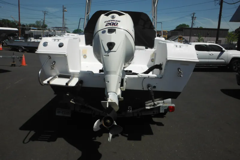 Slide: The Image of 1998 Wellcraft 23 Excel boat with Evinrude 200 engine, parked on a trailer. - 6