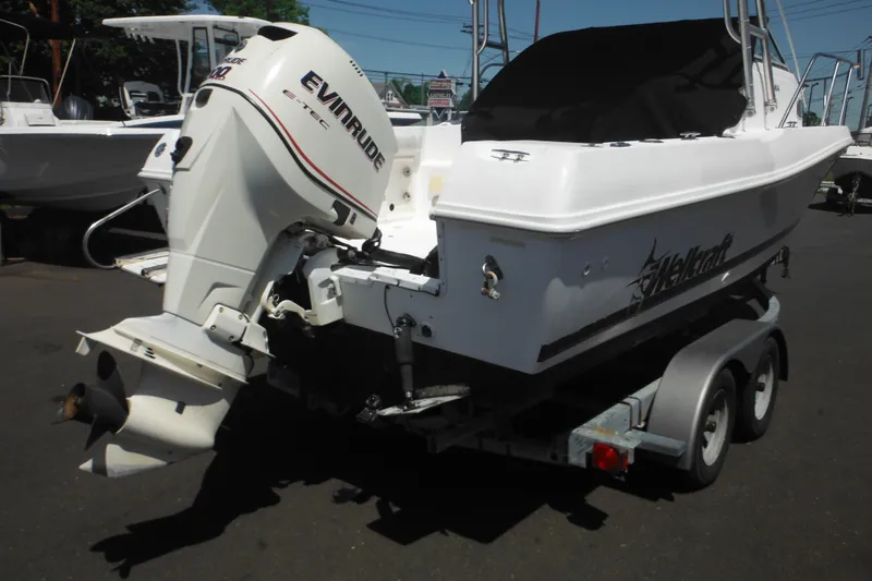 Slide: The Image of 1998 Wellcraft 23 Excel boat with Evinrude engine on a trailer. - 7