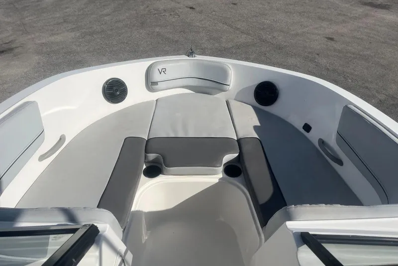 Slide: The Image of 2023 Bayliner VR5 Bowrider OB interior with cushioned seating and speakers. - 10