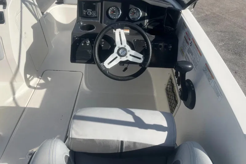 Slide: The Image of 2023 Bayliner VR5 Bowrider OB cockpit with steering wheel and control panel. - 12