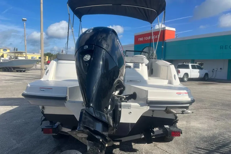 Slide: The Image of 2023 Bayliner VR5 Bowrider OB with outboard motor in a dealership lot. - 13