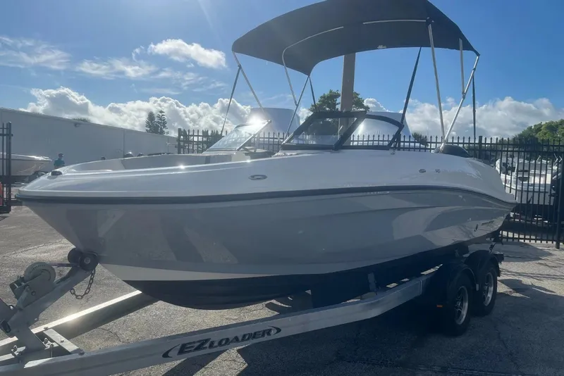 Slide: The Image of 2023 Bayliner VR5 Bowrider OB on trailer under sunny sky. - 3