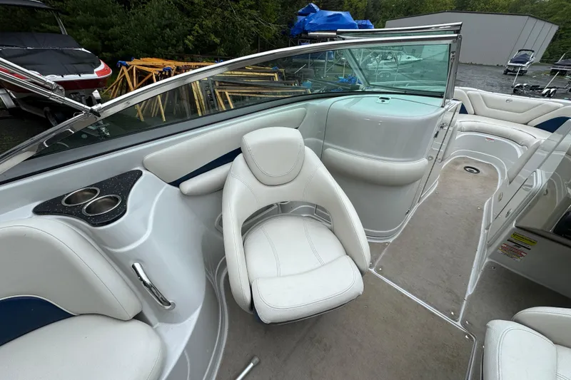 Slide: The Image of 2009 Crownline 240 LS boat interior with white seating and cup holders. - 5