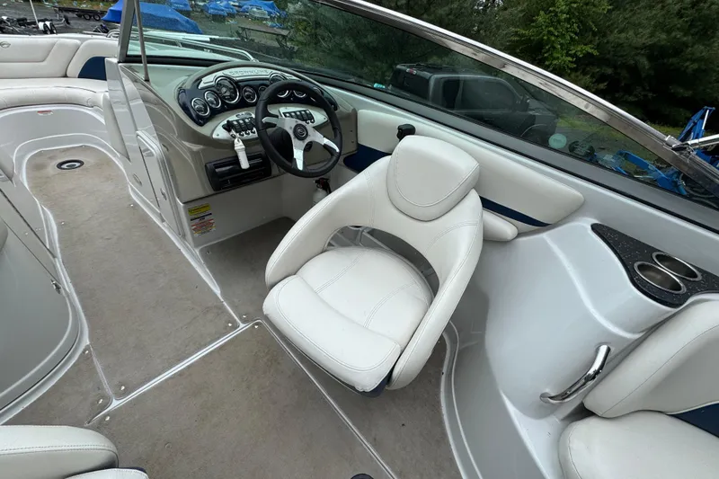 Slide: The Image of 2009 Crownline 240 LS boat interior with steering wheel and seating area. - 7