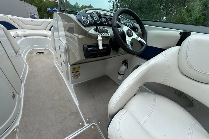 Slide: The Image of 2009 Crownline 240 LS boat interior with steering wheel and seating. - 8
