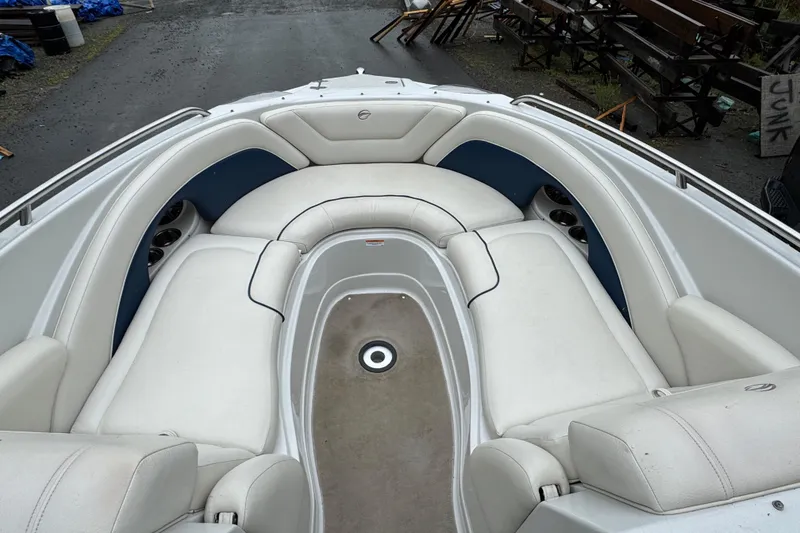 Slide: The Image of 2009 Crownline 240 LS boat interior with white seating and cup holders. - 9