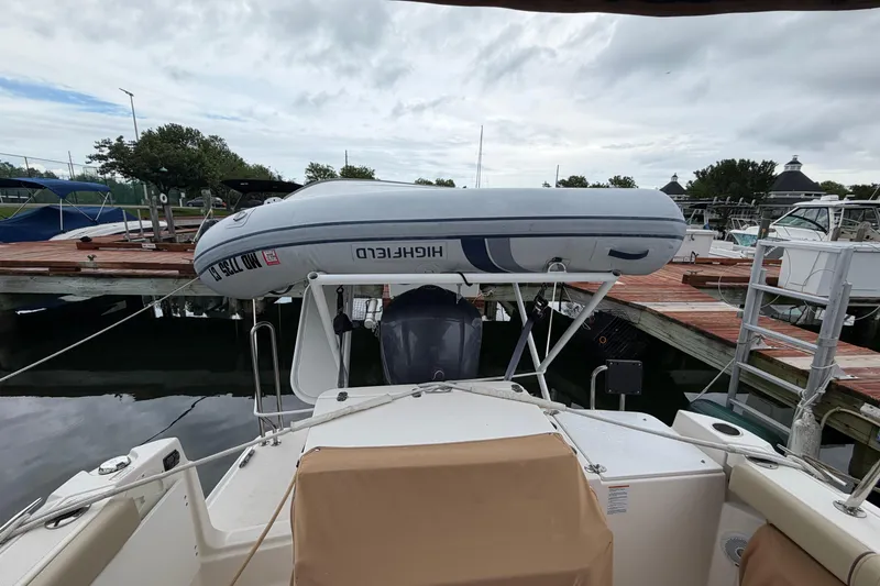 Slide: The Image of 2021 Ranger Tugs R-27 boat with inflatable dinghy at marina dock. - 3