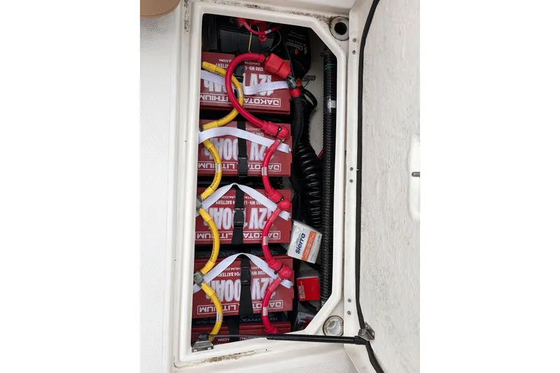 Slide: The Image of Battery compartment of a 2021 Ranger Tugs R-27, featuring multiple lithium batteries. - 8