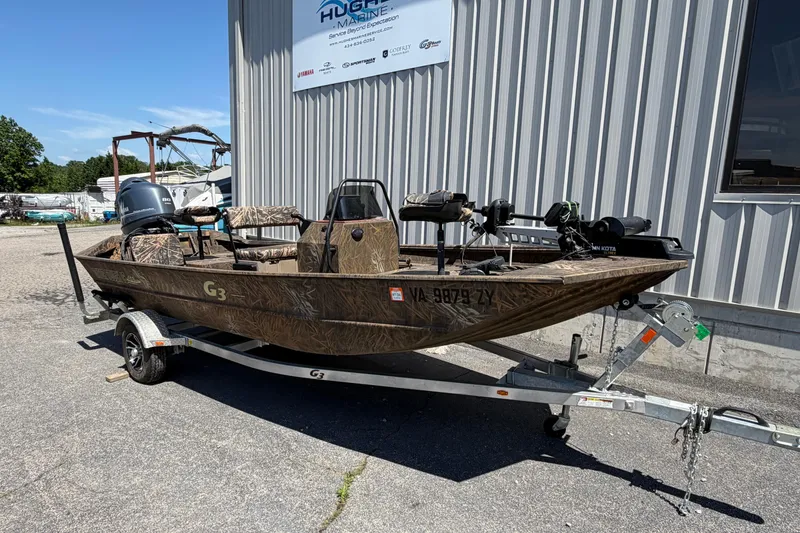 Slide: The Image of 2023 G3 Gator Tough 18 CCJ boat on trailer outside marine shop. - 2