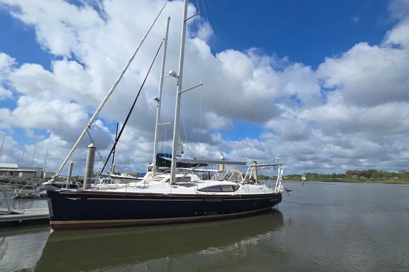 The Image of 2011 Jeanneau Sun Odyssey 50 DS sailboat docked under a cloudy sky. - 0