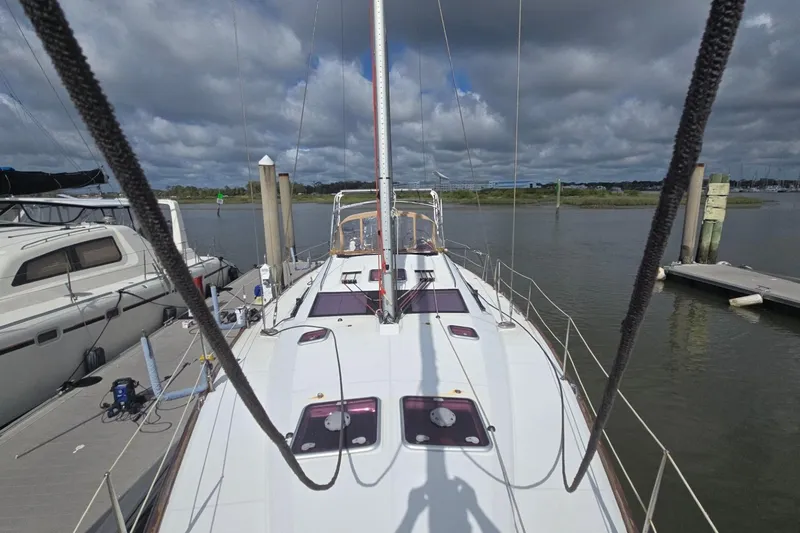 Slide: The Image of 2011 Jeanneau Sun Odyssey 50 DS yacht docked at marina under cloudy sky. - 14