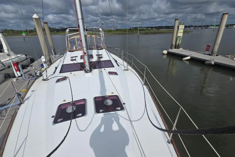 Slide: The Image of 2011 Jeanneau Sun Odyssey 50 DS yacht docked at marina under cloudy sky. - 16
