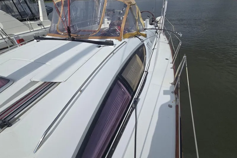 Slide: The Image of 2011 Jeanneau Sun Odyssey 50 DS sailboat deck view, docked on calm water. - 19