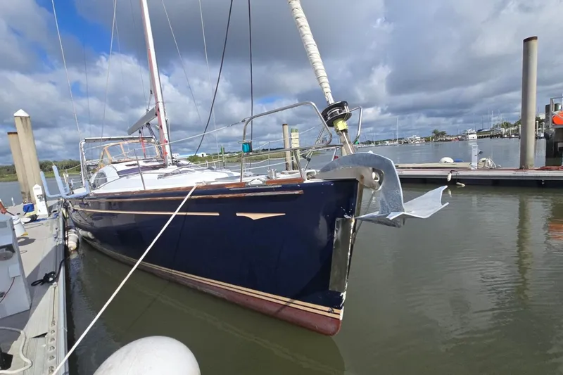 Slide: The Image of 2011 Jeanneau Sun Odyssey 50 DS sailboat docked at marina under cloudy sky. - 2